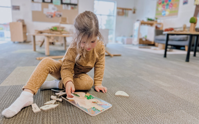 Child exploring puzzles at Little Wonders in Timaru