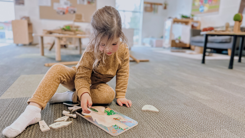 Child exploring puzzles at Little Wonders in Timaru