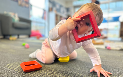 Infant exploring toys at Little Wonders Timaru