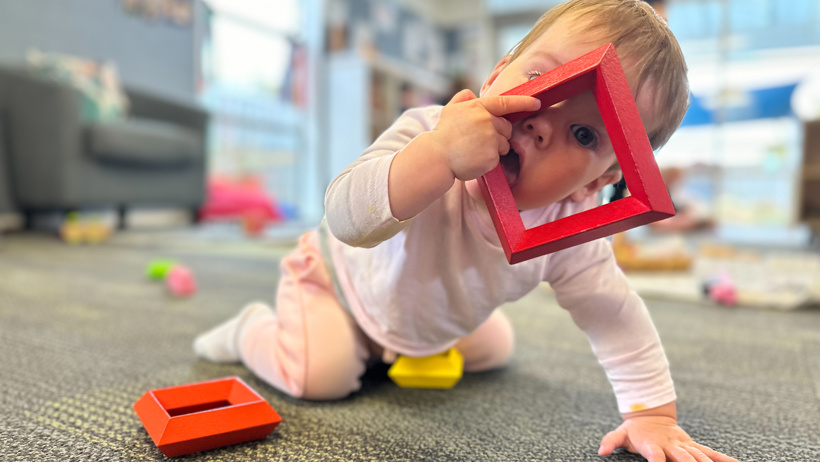 Infant exploring toys at Little Wonders Timaru
