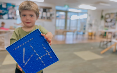 Child showing his geometry creation in the transition to school room at little Wonders Timaru