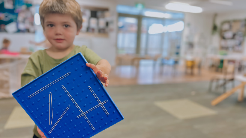 Child showing his geometry creation in the transition to school room at little Wonders Timaru